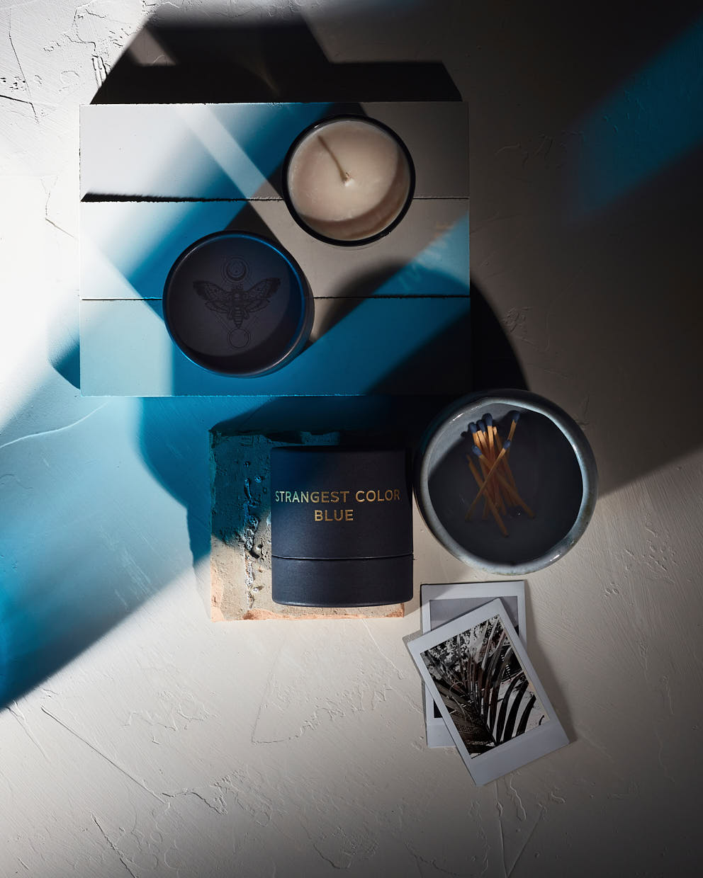 Packaging design by Rebecca Snyder for Tatine Candles, dark, wild & deep collection. Strangest-color blue. Product Photography Services by Matt Snyder A LA MODE designs.