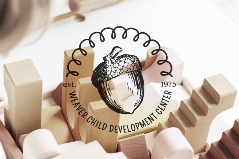 Close-up of wooden toy blocks with the Weaver Child Development Center acorn logo and “est. 1975” overlaid. Brand identity services provided by A LA MODE designs, Rebecca Snyder, lead graphic designer, owner, and award-winning.