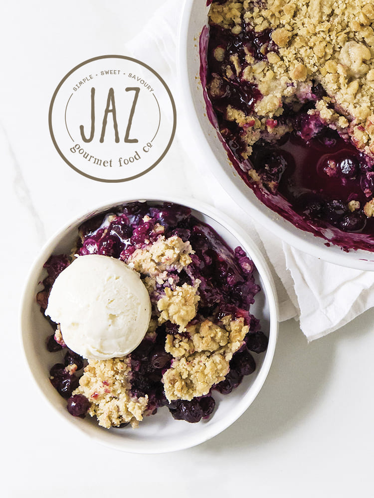 JAZ Gourmet Food Co. circular logo over a food photo of blueberry crumble with a scoop of vanilla ice cream.