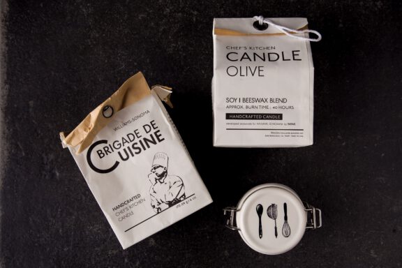 Williams-Sonoma • TATINE ‘Brigade de Cuisine’ packaging displayed with a lidded jar on a dark surface. Package design services by A LA MODE designs, Rebecca Snyder, an International award-winning, graphic designer.