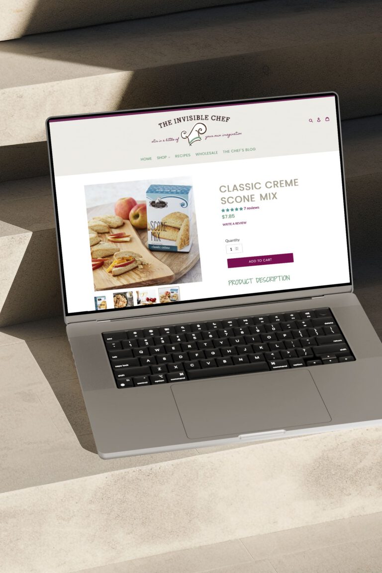 Laptop displaying The Invisible Chef Shopify product page for Classic Creme Scone Mix with an Add to Cart button.